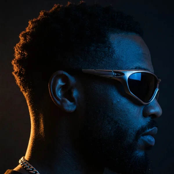 Profile portrait relit with blue front light and a warm amber rim light